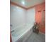 Bright bathroom showcasing a clean, white-tiled bathtub and tiled floors at 810 Hammockwood Ct, Sarasota, FL 34232