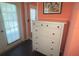 Bedroom featuring sliding doors, white dresser, and natural lighting at 810 Hammockwood Ct, Sarasota, FL 34232