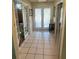 Hallway featuring white tile floors, french doors and neutral colored walls at 810 Hammockwood Ct, Sarasota, FL 34232