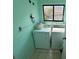 Functional laundry room with washer and dryer and tiled flooring at 810 Hammockwood Ct, Sarasota, FL 34232