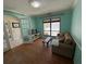 Cozy living room featuring hardwood floors, a comfortable couch, and ample natural light at 810 Hammockwood Ct, Sarasota, FL 34232