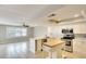 Open kitchen with white cabinets, stainless steel appliances, and a butcher block island at 8111 Timber Lake Ln, Sarasota, FL 34243