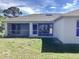 Home with a screened-in lanai, and green lawn at 8314 Drolet Ave, North Port, FL 34291