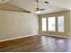 Open living space with wood floors, high ceilings, a ceiling fan, and natural light from windows at 8314 Drolet Ave, North Port, FL 34291