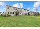 Large backyard with green grass and a covered patio at 8330 Abalone Loop, Parrish, FL 34219