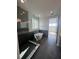 Modern bathroom with glass shower, soaking tub, and dark tile throughout at 8330 Abalone Loop, Parrish, FL 34219
