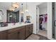 Bathroom features a double sink vanity, large mirror, modern lighting, and walk-in closet at 8330 Abalone Loop, Parrish, FL 34219