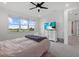 Bright bedroom features a ceiling fan, plush carpet, and a scenic view out the windows at 8330 Abalone Loop, Parrish, FL 34219