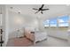 Charming bedroom with decorative ceiling fan, view of green fields, and elegant light fixtures at 8330 Abalone Loop, Parrish, FL 34219