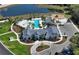 Aerial view of the community pool with seating, recreational amenities, and lake views at 8330 Abalone Loop, Parrish, FL 34219