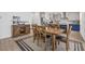 Elegant dining area with a wooden table and chairs, adjacent to a modern kitchen and living space at 8330 Abalone Loop, Parrish, FL 34219