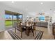Dining room featuring a dining table with seating for four overlooking the living room and outdoor patio at 8330 Abalone Loop, Parrish, FL 34219