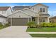 Two story home featuring a two car garage and a well manicured lawn at 8330 Abalone Loop, Parrish, FL 34219