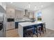 Modern kitchen featuring stainless steel appliances, kitchen island with barstool seating, and pendant lighting at 8330 Abalone Loop, Parrish, FL 34219