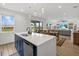 View of kitchen island with stainless steel dishwasher and sink overlooking the dining and living room at 8330 Abalone Loop, Parrish, FL 34219