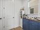 Wet bar area with blue cabinets, a coffee machine, and a view out the window at 8330 Abalone Loop, Parrish, FL 34219