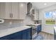 Bright kitchen features modern two-tone cabinetry, stainless steel appliances, and stylish tile backsplash at 8330 Abalone Loop, Parrish, FL 34219