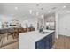 Kitchen with large island, stainless steel appliances, and open floor plan to the living and dining area at 8330 Abalone Loop, Parrish, FL 34219