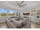 Spacious living room with tile floors, a ceiling fan, and large sectional sofa at 8330 Abalone Loop, Parrish, FL 34219