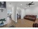 Comfortable living room space with hardwood floors, a ceiling fan, and a brown leather sofa at 8330 Abalone Loop, Parrish, FL 34219
