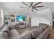 Living room with tile floors, sectional sofa, ceiling fan, and wall mounted tv at 8330 Abalone Loop, Parrish, FL 34219