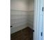 Walk-in pantry features wood-look flooring, custom shelving, and ample storage space at 8330 Abalone Loop, Parrish, FL 34219