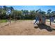 Community playground with climbing structure, slide, and wood chip groundcover at 8330 Abalone Loop, Parrish, FL 34219