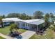 Aerial view of a well-maintained home with mature landscaping and a spacious driveway at 8409 Imperial Cir, Palmetto, FL 34221