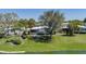 Waterfront community home with lush green lawn and mature shade trees at 8409 Imperial Cir, Palmetto, FL 34221