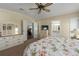 Bedroom features light carpet, ceiling fan, and adjoining doors to other rooms at 8409 Imperial Cir, Palmetto, FL 34221