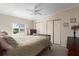 Neutral bedroom features a ceiling fan, window view, and closet at 8409 Imperial Cir, Palmetto, FL 34221