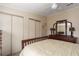 Bedroom features a full dresser with mirror and a double door closet at 8409 Imperial Cir, Palmetto, FL 34221