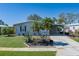 Single-story home with meticulous landscaping, a carport, and a paved driveway at 8409 Imperial Cir, Palmetto, FL 34221