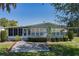 Charming single-story home with a well-manicured lawn and mature landscaping at 8409 Imperial Cir, Palmetto, FL 34221