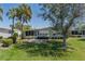 Charming single-story home featuring a well-maintained lawn, tasteful landscaping, and a screened-in porch for outdoor enjoyment at 8409 Imperial Cir, Palmetto, FL 34221