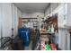 Cluttered garage with shelving and a workbench, with a bicycle and storage containers at 8409 Imperial Cir, Palmetto, FL 34221