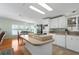 Spacious kitchen features white cabinets, an island cooktop, with views to the dining area and water at 8409 Imperial Cir, Palmetto, FL 34221