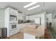 Bright kitchen with white cabinets, modern appliances, and an island cooktop at 8409 Imperial Cir, Palmetto, FL 34221