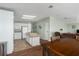 Well-lit kitchen featuring white cabinets, a center island with cooktop, and views of the living space at 8409 Imperial Cir, Palmetto, FL 34221