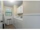 Functional laundry room with washer, dryer, and storage cabinets at 8409 Imperial Cir, Palmetto, FL 34221