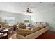 Bright living room featuring hardwood floors, couches, and a day bed at 8409 Imperial Cir, Palmetto, FL 34221