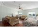 Well-lit living room with hardwood floors, comfortable furniture, and ceiling fan at 8409 Imperial Cir, Palmetto, FL 34221