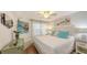 Bright bedroom with white bedding, colorful accent pillows and hardwood flooring at 850 S Tamiami Trl # 307, Sarasota, FL 34236