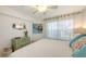 Bright bedroom with white bedding, colorful accent pillows, and decorative furniture at 850 S Tamiami Trl # 307, Sarasota, FL 34236