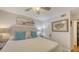 Bedroom with plush bedding, hardwood floors and decorative wall art at 850 S Tamiami Trl # 307, Sarasota, FL 34236