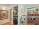 Laundry room with stackable washer and dryer, storage shelving, and adjacent bathroom at 850 S Tamiami Trl # 307, Sarasota, FL 34236