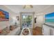 Bright living room with a white sofa, wood floors, and sliding doors to the patio at 850 S Tamiami Trl # 307, Sarasota, FL 34236
