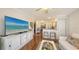 Open living area with a ceiling fan, breakfast bar and a large television set at 850 S Tamiami Trl # 307, Sarasota, FL 34236