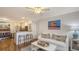 Open living area with a ceiling fan, breakfast bar and a comfortable white couch at 850 S Tamiami Trl # 307, Sarasota, FL 34236
