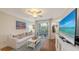 Cozy living room featuring a sofa, entertainment center, and access to the outdoor patio at 850 S Tamiami Trl # 307, Sarasota, FL 34236